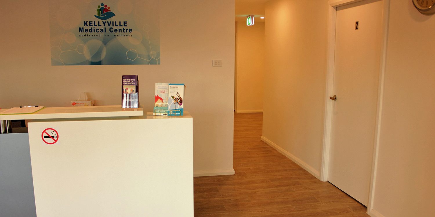 The reception desk, with the practice logo on the wall